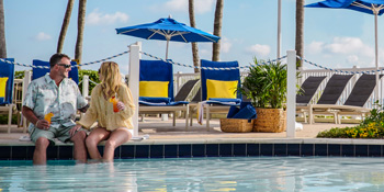 couple with drinks at the pool